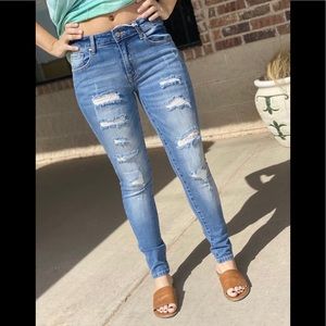 NWOT Distressed medium wash stretch skinnies.